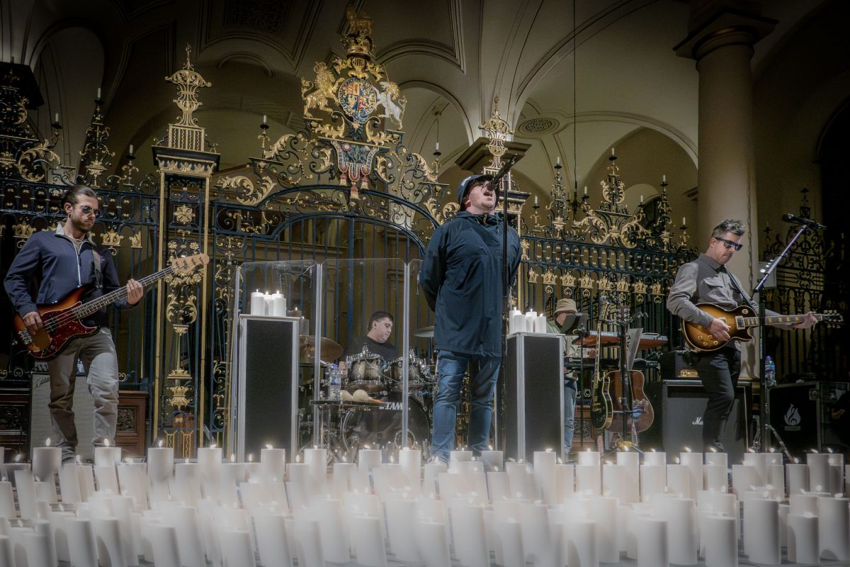 The Oasis tribute band performing by candlelight at derby cathedral surrounded by candles
