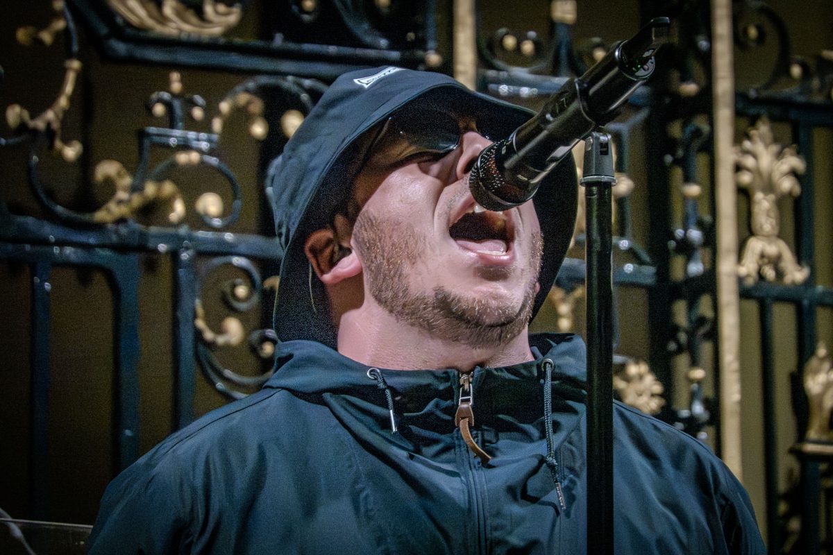 The lead singer of the Oasis tribute band performing by candlelight at derby cathedral