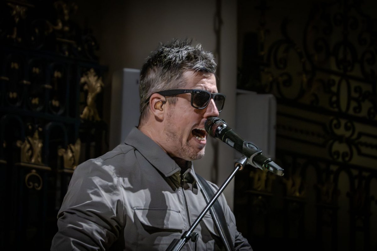 Oasis tribute bands lead guitarist performing by candlelight at derby cathedral