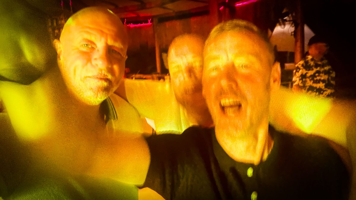 Three friends enjoying a lively night out with bright yellow lighting at Titanic Mardan Palace