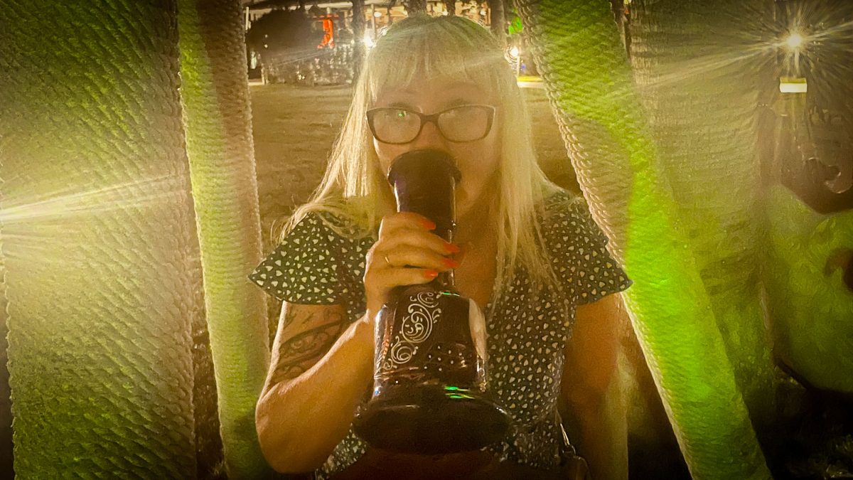 Woman enjoying a relaxed evening drink with warm lighting at Titanic Mardan Palace