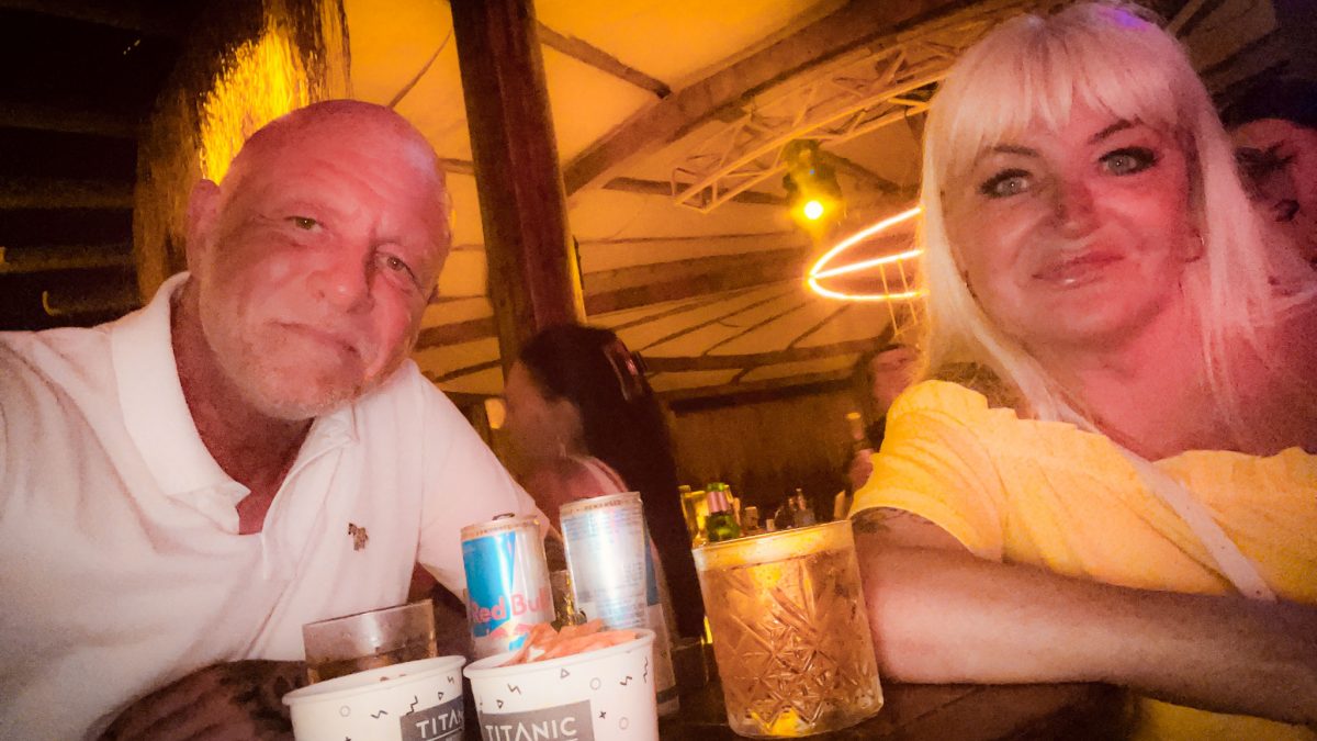 A couple enjoying evening drinks at the bar in Titanic Mardan Palace with warm lighting and drinks on the table