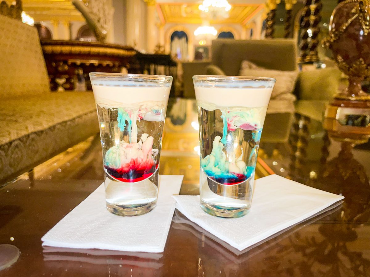 Two colourful Monkey Brains shot drinks on a glass table inside the luxurious Mardan Palace in Antalya.