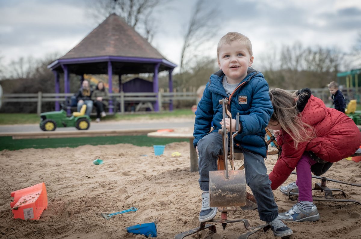 Young boy playing in the sandpit at Wheelgate Park in Nottinghamshire
