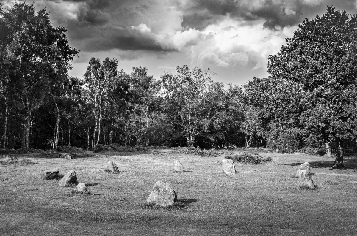 Black and white photograph of the Nine Ladies Stone Circle, an ancient Bronze Age monument located on Stanton Moor, Derbyshire, UK.