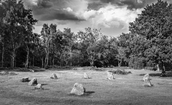 Black and white photograph of the Nine Ladies Stone Circle, an ancient Bronze Age monument located on Stanton Moor, Derbyshire, UK.