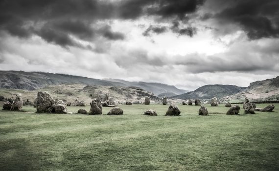 Castlerigg Stone Circle under dark clouds, overlooking the fells near Keswick in the Lake District.