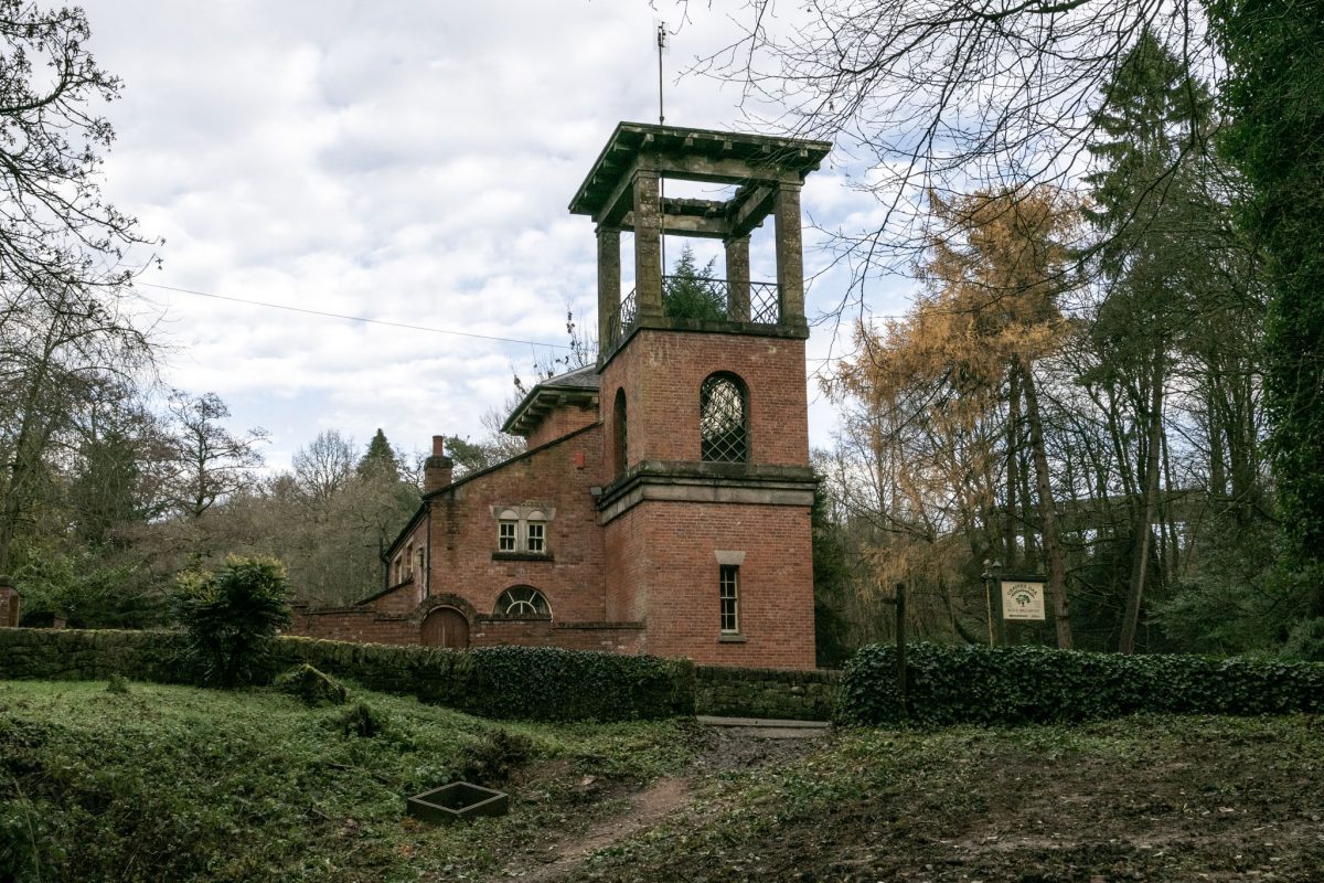 An image of the historic Chained Oak B&B, a brick building with a viewing tower, near the cursed oak and Alton Towers.