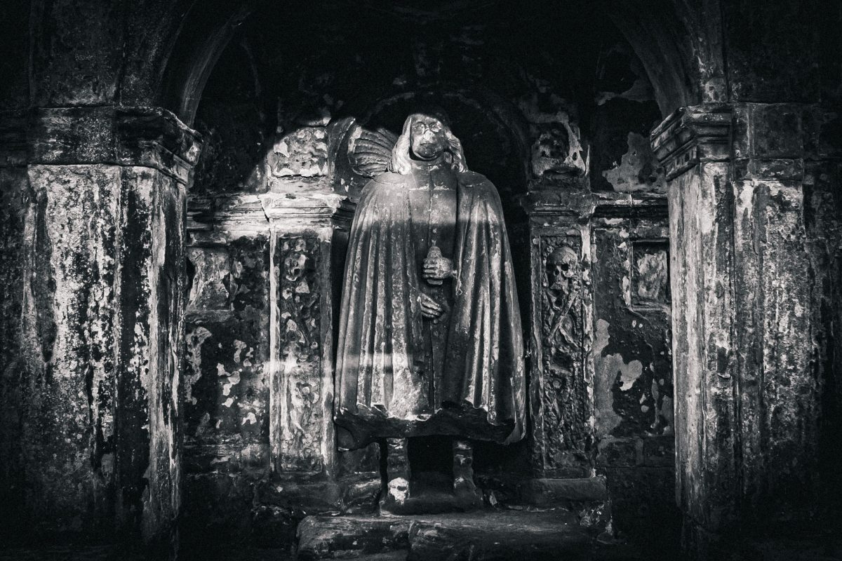 Dark, cloaked statue effigy in a Greyfriars Kirkyard vault.