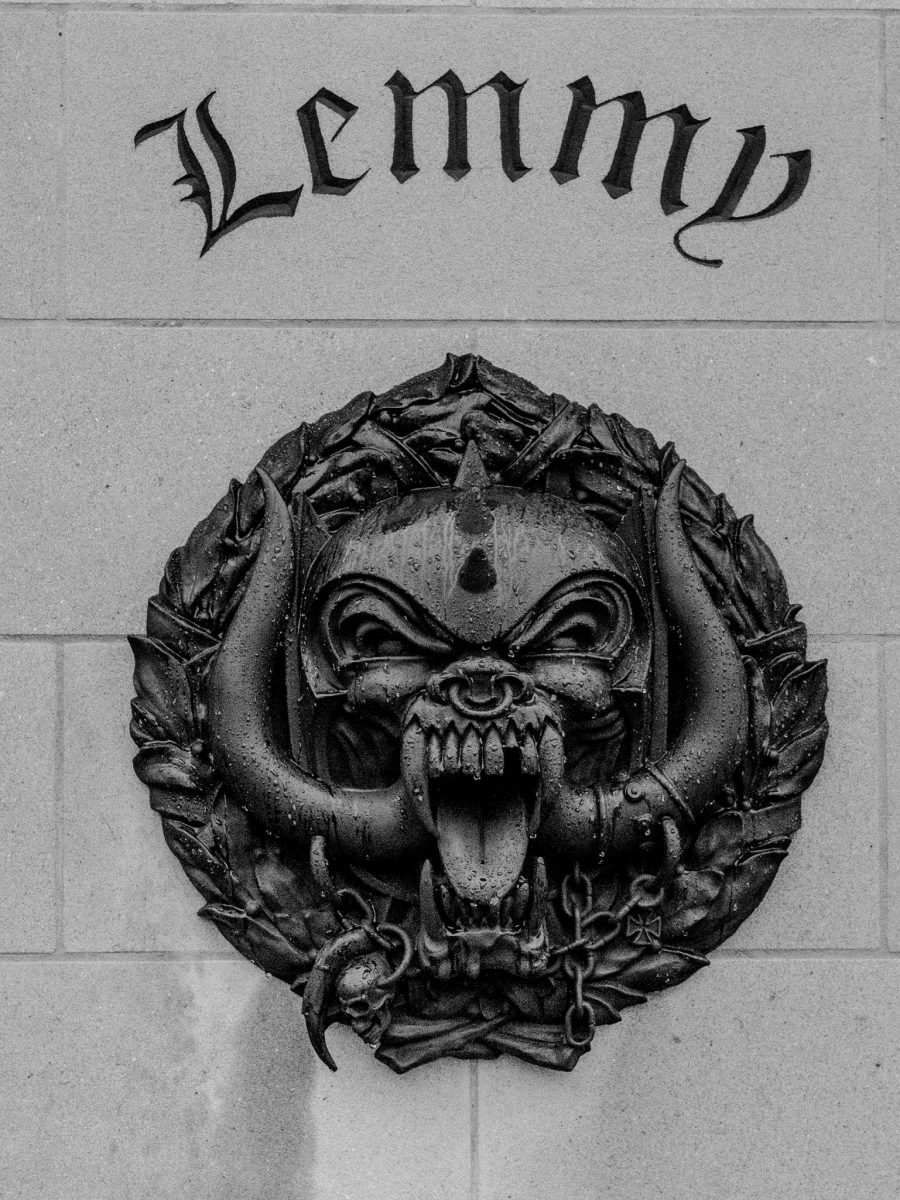 Black and white close-up of the Motörhead 'Snaggletooth' logo relief on the Lemmy memorial plinth in Burslem.