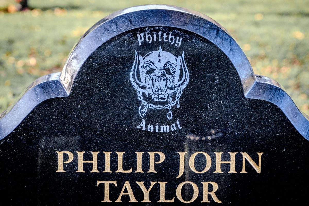Close-up of 'Snaggletooth' logo and "PHILTHY ANIMAL" on the grave.