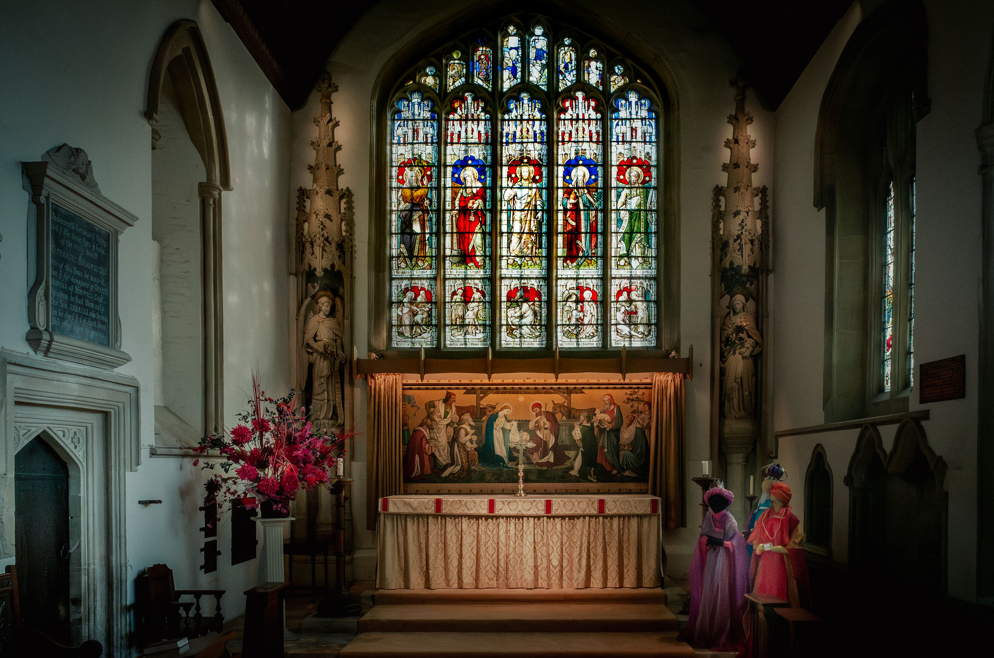 Stained glass window and altar in Burford Church, Oxfordshire.
