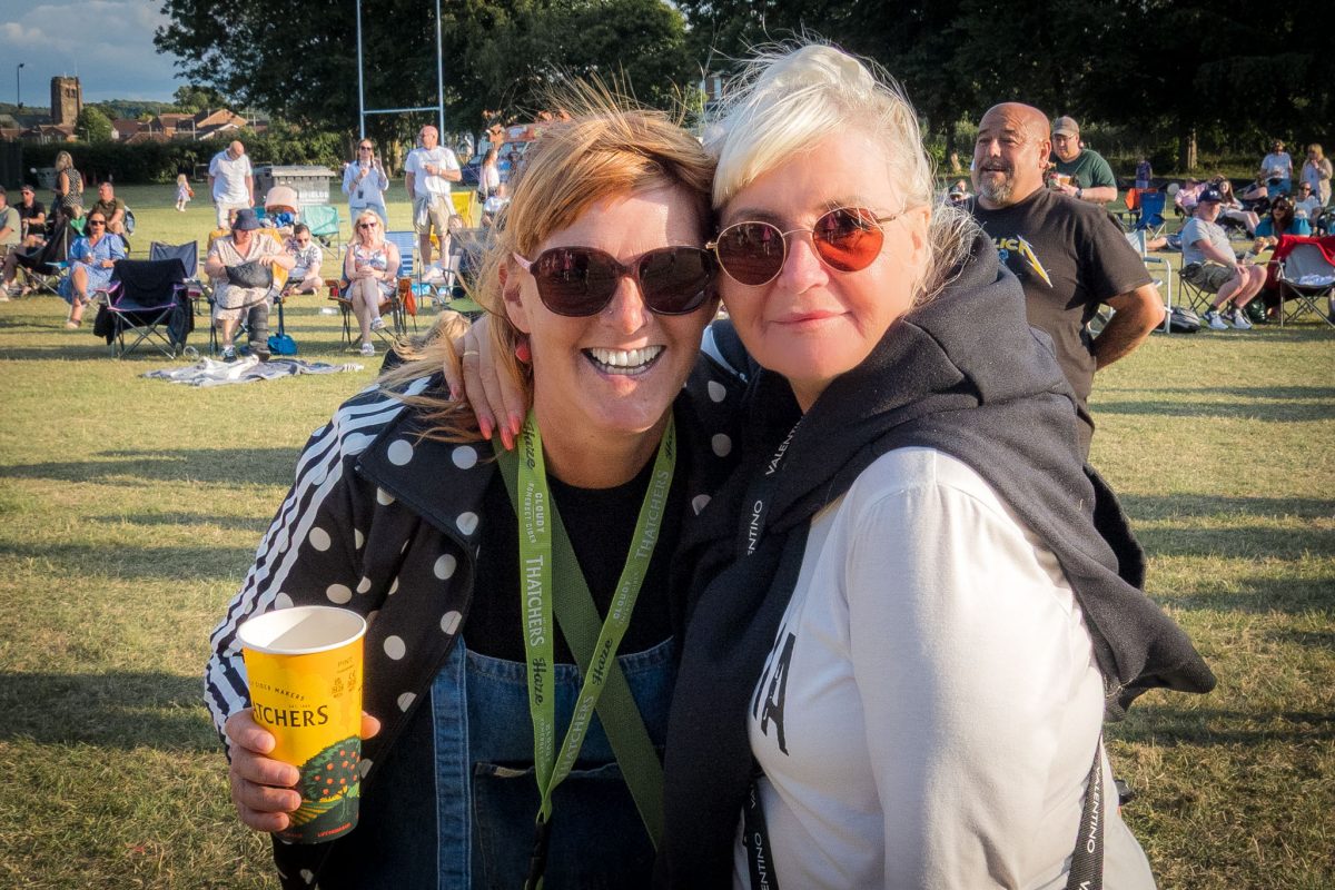 Two smiling friends embracing at Spongefest Worksop