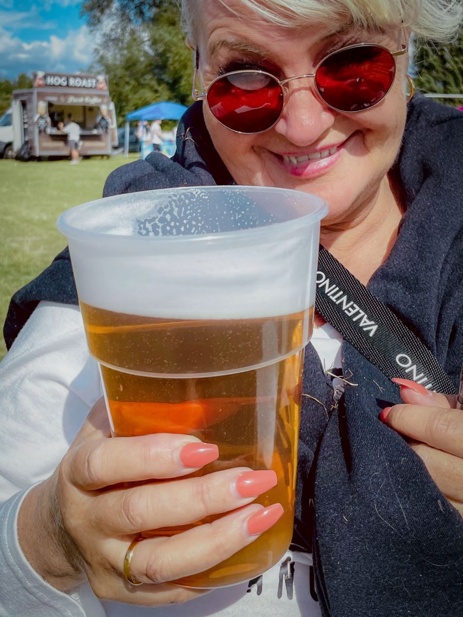 Close-up of a pint of beer held by a festival attendee