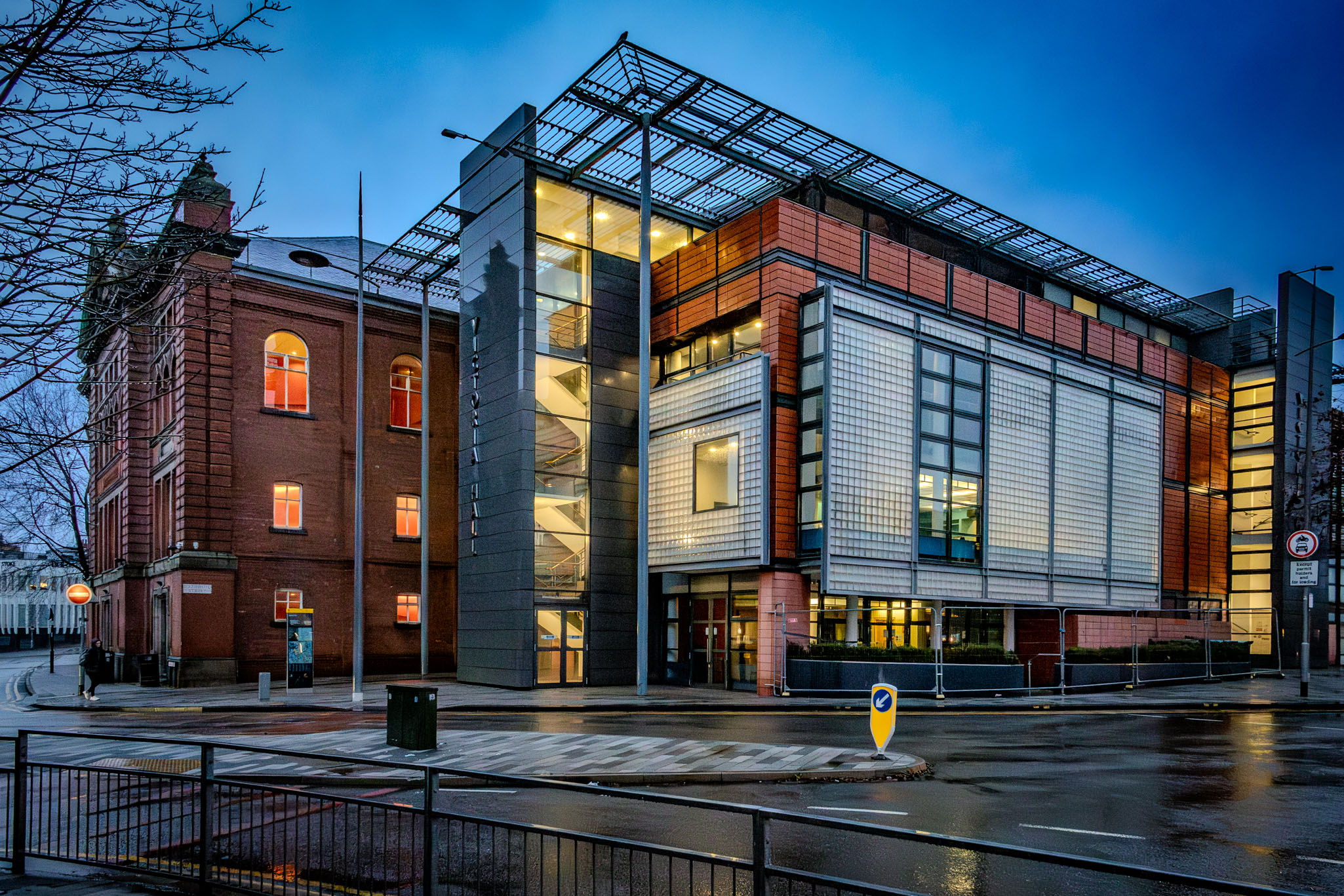 Exterior view of the historic red-brick Victoria Hall in Hanley at dusk.