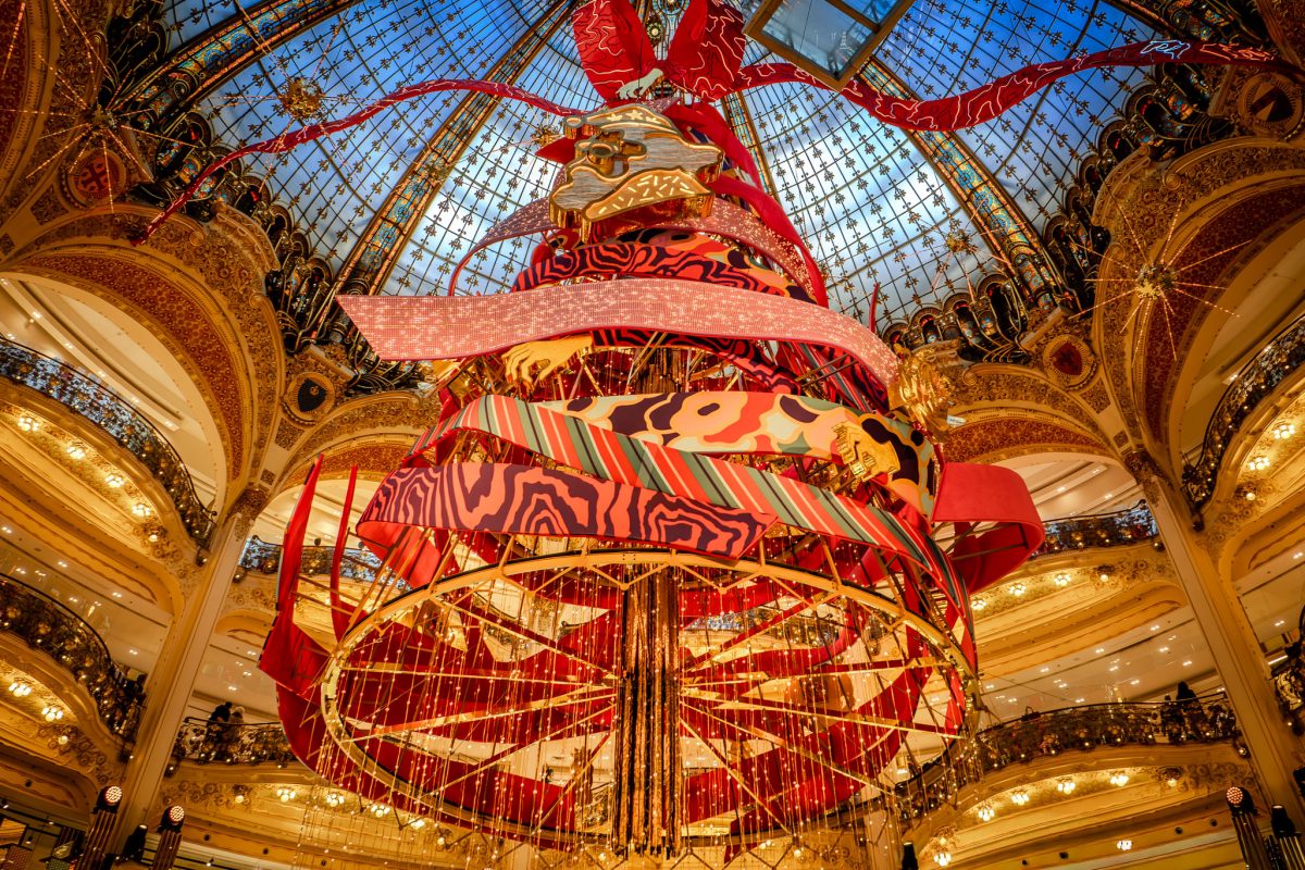 The giant decorated Christmas tree under the ornate glass dome of Galeries Lafayette in Paris.