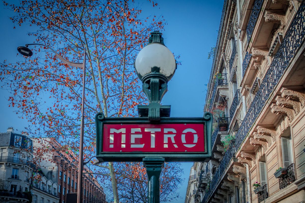 A classic Paris Metro sign with light on top