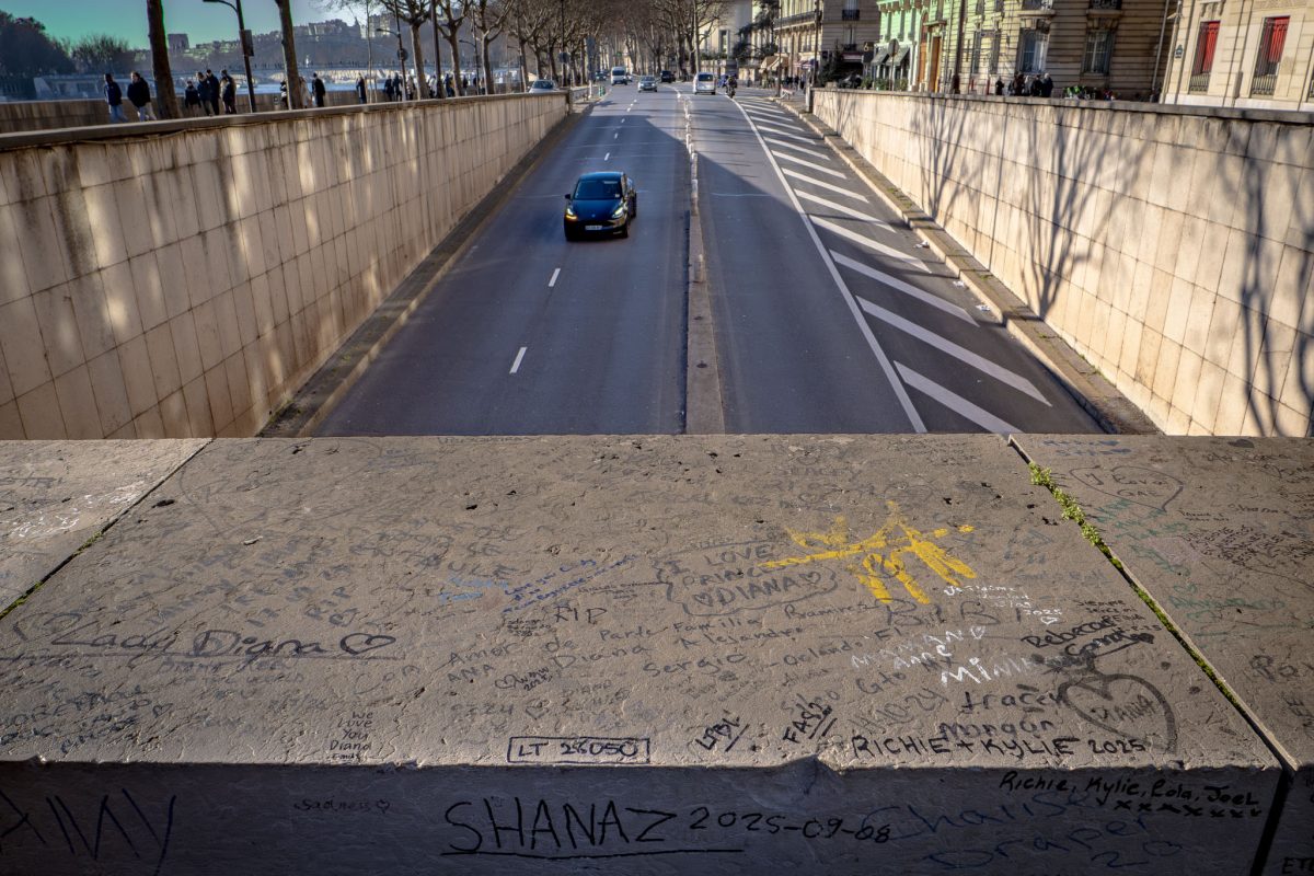 Hand-written messages and graffiti dedicated to Princess Diana on a stone wall overlooking the tunnel.